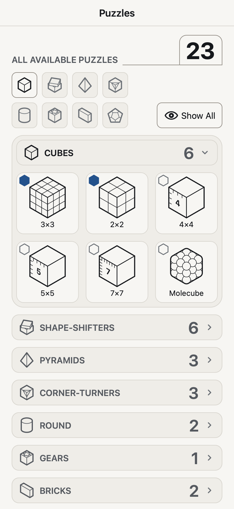 The app's puzzles page: the count of 23, a row of family icons with the Show All button, the Cubes family open with its 6 puzzles drawn and named, and the other families listed below it with their counts.